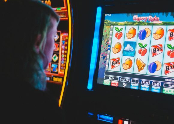 compulsive gambling man playing slot machine game